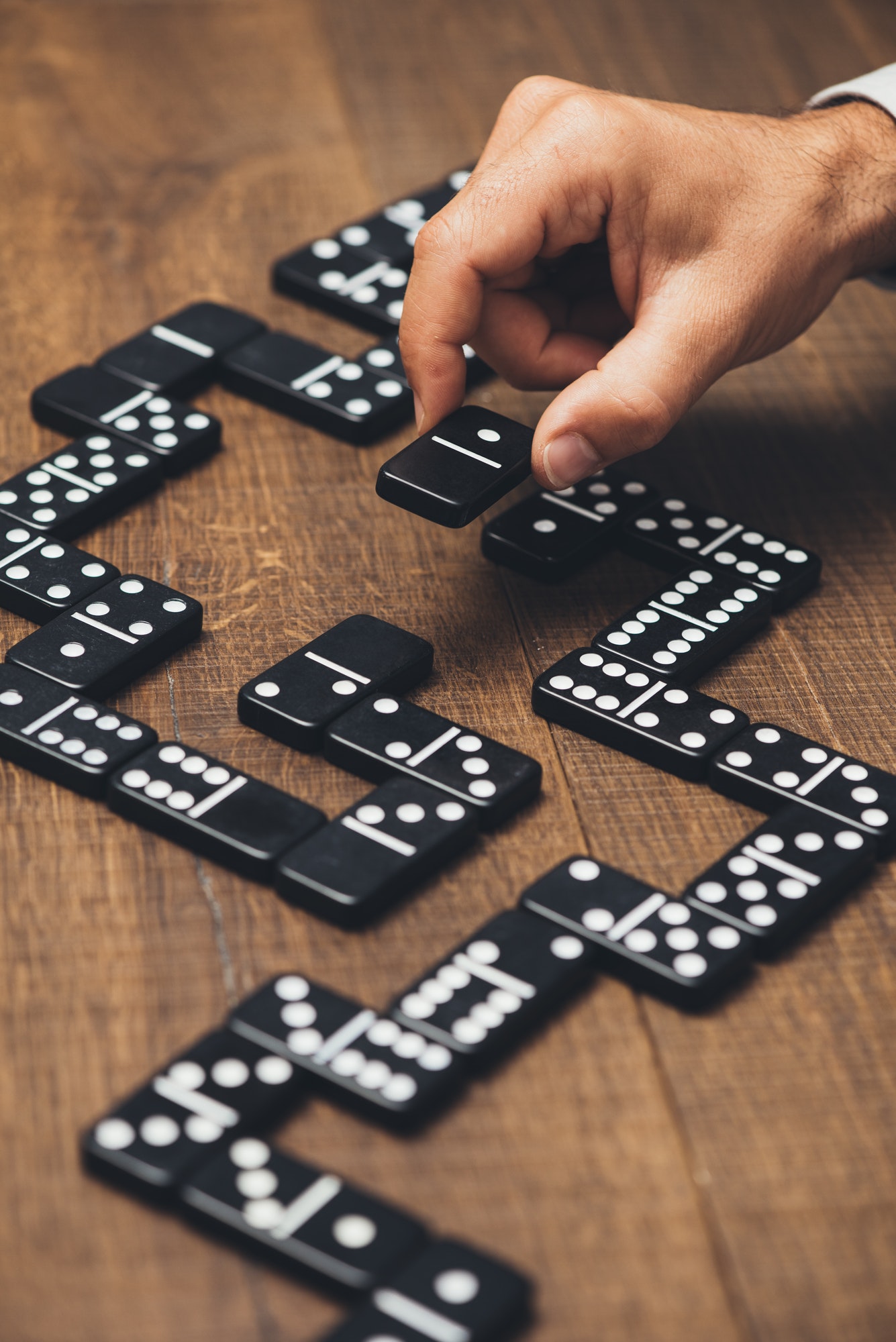 Businessman playing with dominoes